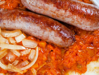  close up of Traditional South African Pap and Wors, sausage with popular maize meal staple covered...