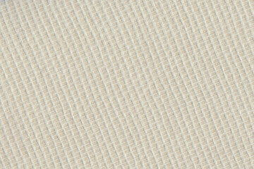 Woven glass fiber wallpaper against a light yellow background. Meant as background