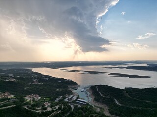 Aerial view of Lake Travis and the Texas Hill Country during a passing thunderstorm at sunset.