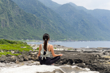 Fototapeta na wymiar Practicing morning meditation in nature at the beach