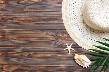 Summer holidays. Summer concept with straw hat and tropical leaf. Flat lay, top view, copy space