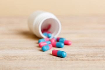 plastic medicine bottle with capsules of pills on colored background. Online pharmacy. Painkiller medicine and antibiotic drug resistance concept. Pharmaceutical industry