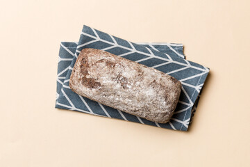 Fresh rye bread on napkin on rustic background, fresh bread top view