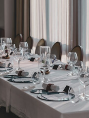 Empty glasses and plates set for a luxuary dinner in restaurant.