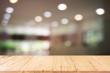 Empty wooden table in front of abstract blurred background of coffee shop . can be used for display Mock up  of product