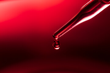 Macro science experiment pipette surface, top macro view of chemical droplet injecting oil into...