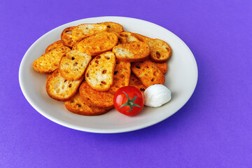 Slices of toasted bread with tomato and mozzarella flavor on a plate