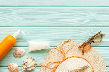 Sunprotection set with sunscreen cosmetic and straw hat. Summer beach concept flatlay