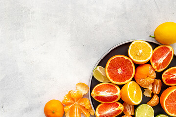 Plate of fresh citrus fruits slices oranges and grapefruits