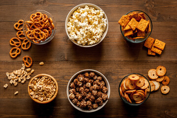 Bowls with different salty snacks for party. Fast food background