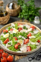 Healthy salad with boiled chicken breast, cherry tomatoes, quail eggs, parmesan and lettuce