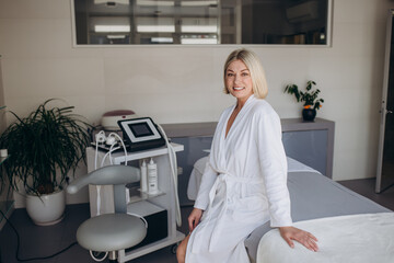 portrait of a female client in a white coat at a beautician