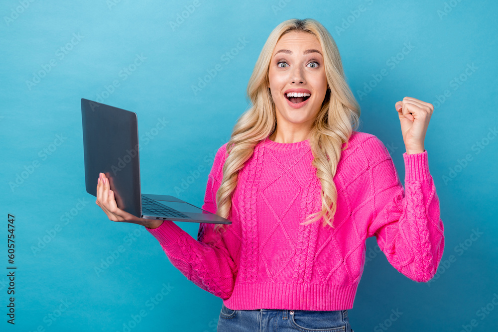 Sticker Photo of ecstatic overjoyed girl wavy hairdo dressed pink sweater hold laptop celebrate winning lottery isolated on blue color background