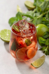 Cocktail Cuba Libre with rum, cola, mint, and lime.