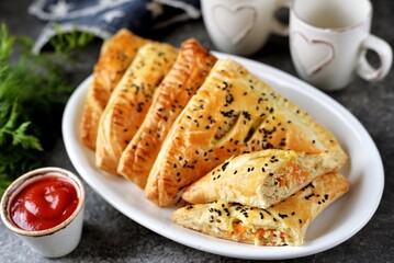 Homemade puff pastries with meat and sesame seeds