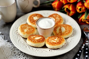 Soft cottage cheese pancakes fried in a pan.