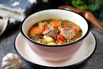 Thick soup with beef, potatoes, tomatoes and bell peppers.