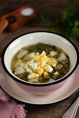 Healthy sorrel and spinach soup with egg and turkey breast.