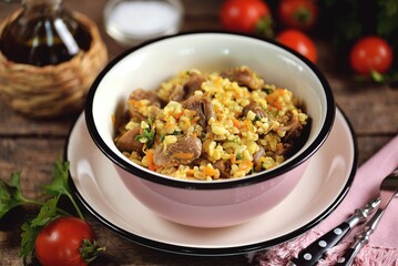 Chicken gizzards stewed with vegetables and bulgur.