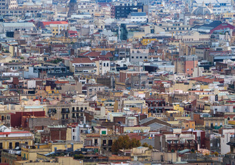Fototapeta na wymiar Aerial panoramic view of Barcelona, Spain. Cityscape with buildings background, top view on the old town from birds eye. Houses and rooftops of Barcelona, urban background of city roofs, top view.