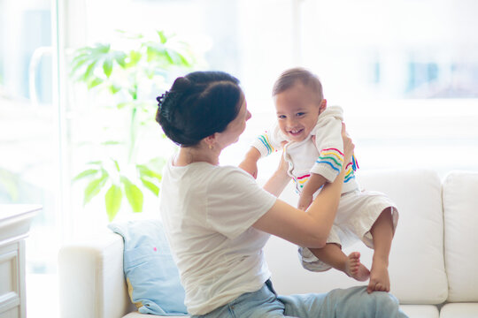 Baby and mother at home. Mom and child.