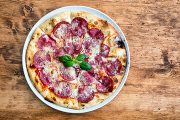 Salami pizza with cheese and basil leaf