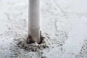 metal drill bit make holes in concrete wall with industrial drill. Building work industry.