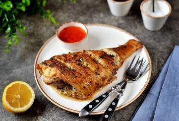 Sea fish baked with herbs, garlic, lemon juice and soy sauce