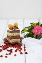 Dessert, piece of banana cake, on a white table, wooden background, photo backdrop, sweet snack, energy, holiday, delicacy,сake with rose