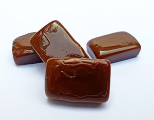 Coffee caramel toffee candies isolated on white background.