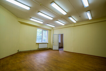 A fragment of the interior of an empty room with an open door