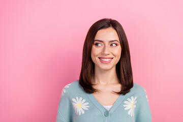 Fototapeta premium Photo of young lovely lady look side empty space white teeth smile banner wear print cardigan isolated pink color background