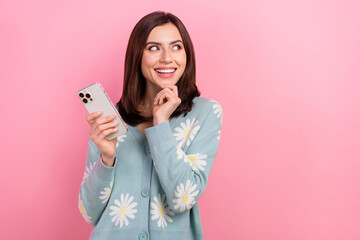 Fototapeta premium Photo of dreamy sweet woman dressed teal outfit looking empty space communicating modern gadget isolated pink color background