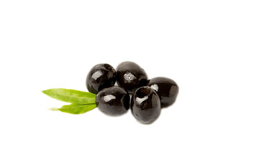 Tasty black olives with leaves isolated on white background. Fresh fruit olives on a white background.