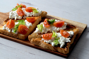 Toast with fresh cottage cheese and cherry tomato