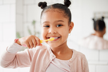 Child, toothbrush and brushing teeth in a home bathroom for dental health and wellness with smile. Face portrait of african girl kid cleaning mouth with a brush for morning routine and oral self care