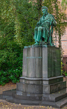 Copenhagen, Denmark - September 14, 2010: Closeup of Soren Aabye Kierkegaard by Louis Hasselriis green bronze statue on pedestal in Royal Library garden