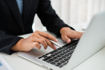 Close up hand of businesswoman&rsquo;s sitting in the office room and using computer notebook.