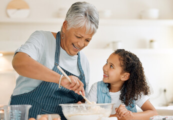 Grandmother, happy or child baking in kitchen as a happy family with young girl learning cookies...