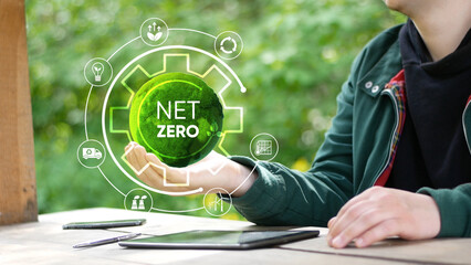 Net zero and carbon neutral concept.Globe Glass with Net zero icons In Green Forest With Sunlight. net zero greenhouse gas emissions target Climate neutral long term strategy on a green background