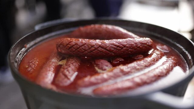 delicious sausages cooked in the pot. hotdog sale