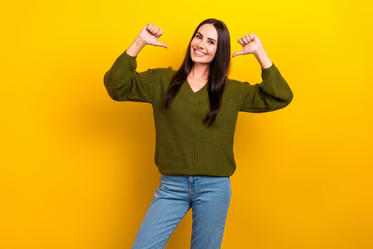 Photo of shiny adorable woman dressed khaki sweater pointing thumbs herself isolated yellow color background