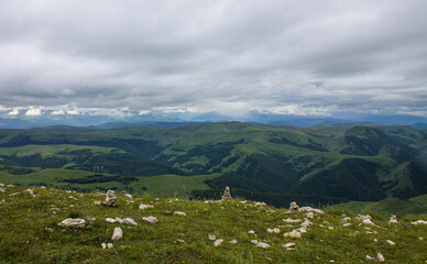 Fantastic dramatic landscape - panoramic view of the hilly valley blurred in the morning fog from...