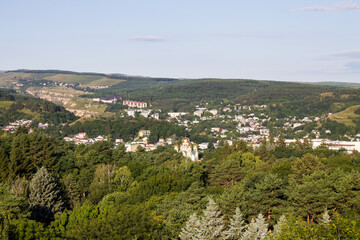 Fototapeta premium Panoramic top view of the city of Pyatigorsk in Russia on a cloudy summer day and a copy space on the horizon