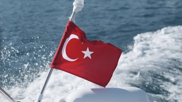Turkish flag waving on a boat in the sea