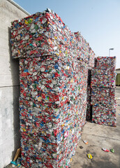 Blocks of crushed aluminum cans at a recycling plant.