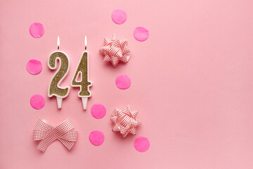 Number 24 on pastel pink background with festive decor. Happy birthday candles. The concept of celebrating a birthday, anniversary, important date, holiday. Copy space. Banner