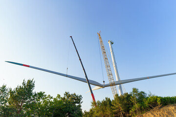 Wind turbines being hoisted and under construction