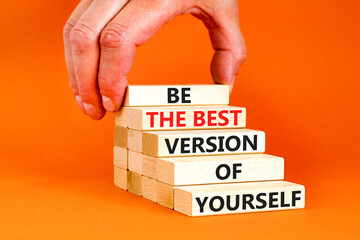 Motivational inspirational symbol. Concept words Be the best version of yourself on wooden block. Beautiful orange background Businessman hand. Business motivational inspirational concept. Copy space.