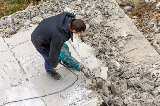 Construction worker with pneumatic hammer intended to drill the cement and concrete floors.